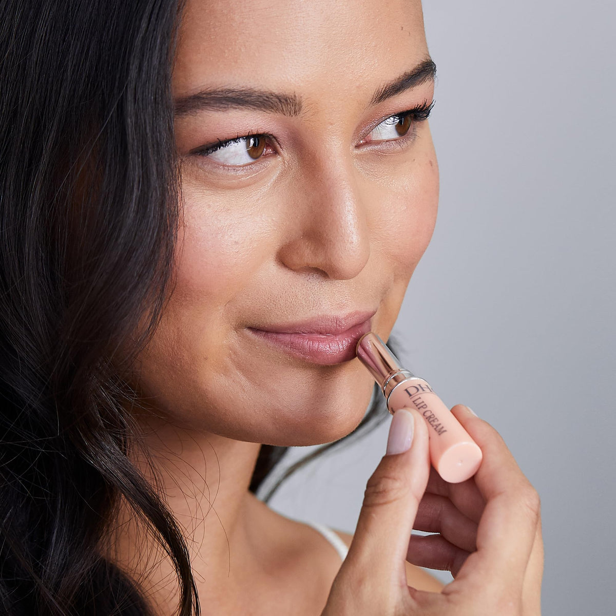 DHC lip cream layered over lipstick showing added shine without color change