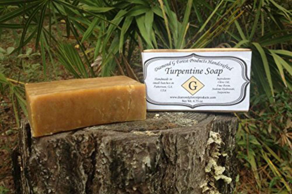 Diamond G Forest Products turpentine soap beside hunting gear showing scent-masking benefit