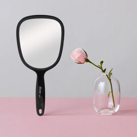 Diane close-up of mirror surface highlighting clear reflection for precise makeup