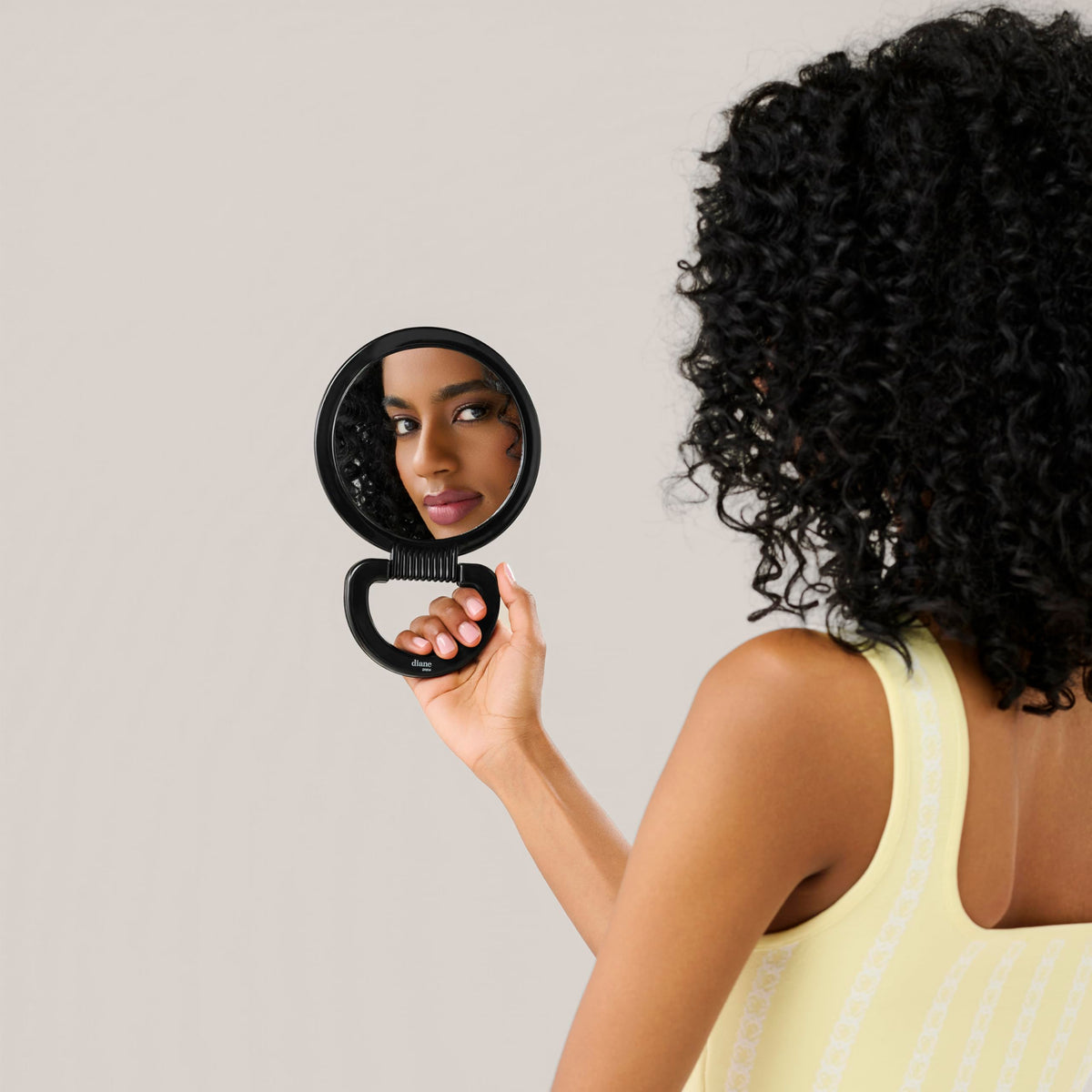 Diane handle flipped to form a tabletop stand for hands-free makeup