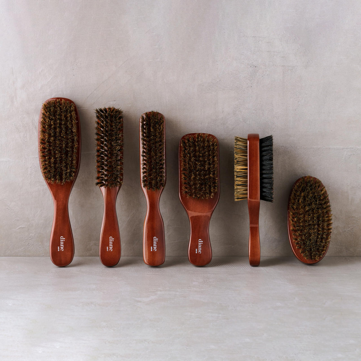 Diane brush used on curly hair to smooth and define texture for a neat finish