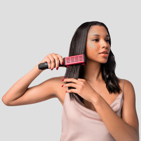 Diane brush held in hand for scale showing comfortable grip and travel-friendly size