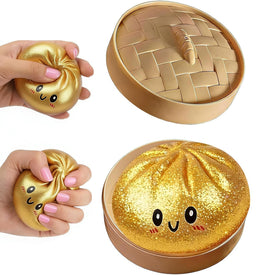DICSINM dumpling squishy front view showing playful gold finish and realistic folds