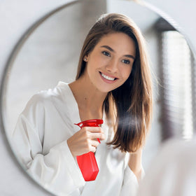 DilaBee bottle held in hand showing compact size and ergonomic grip benefit