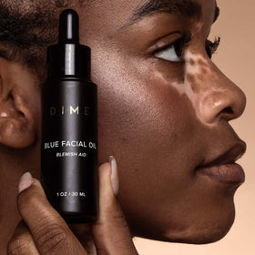 DIME blue facial oil applied to hand demonstrating lightweight, non-greasy finish