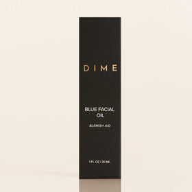 DIME blue facial oil on bedside table illustrating evening routine calming benefits