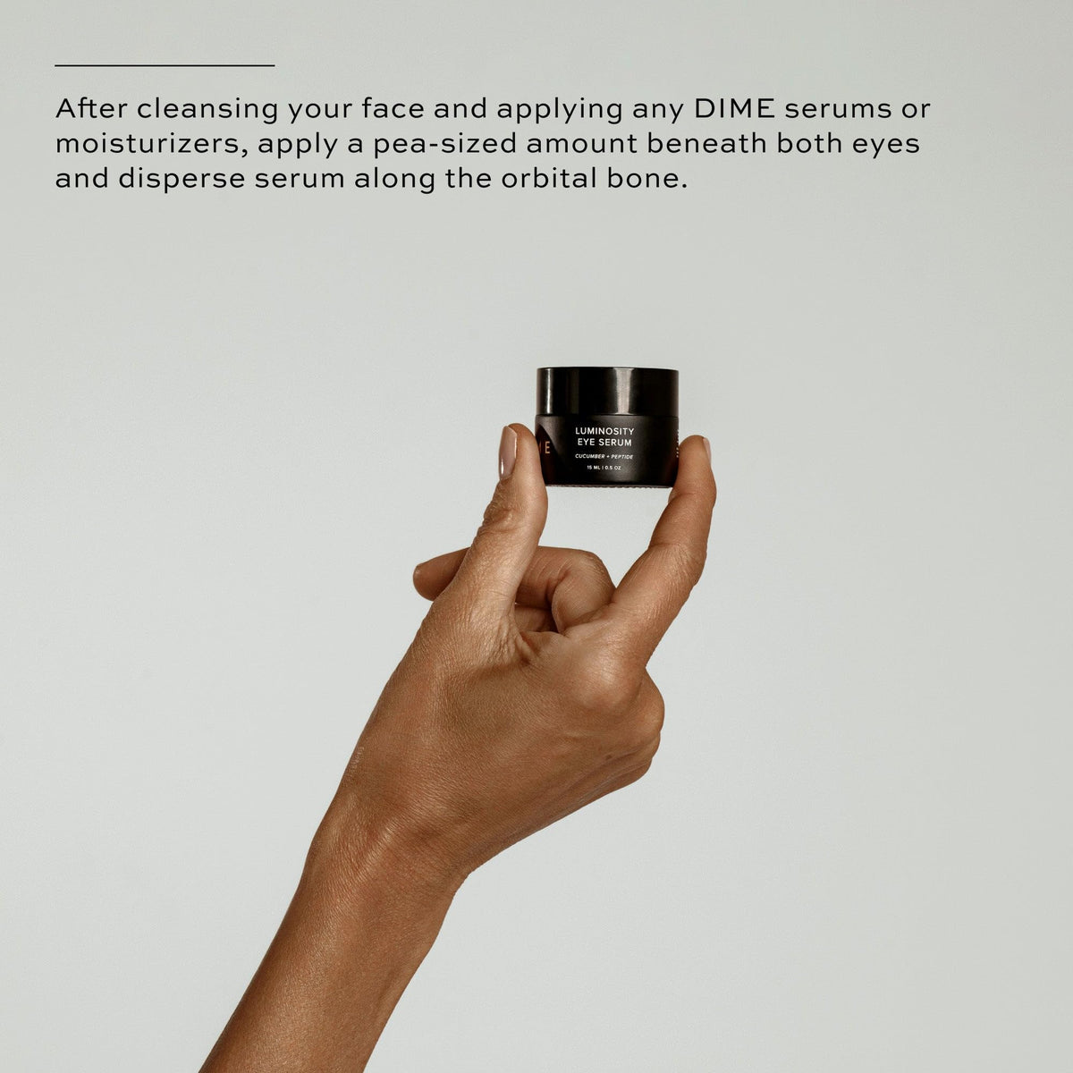 DIME bottle in hand demonstrating compact travel-friendly size
