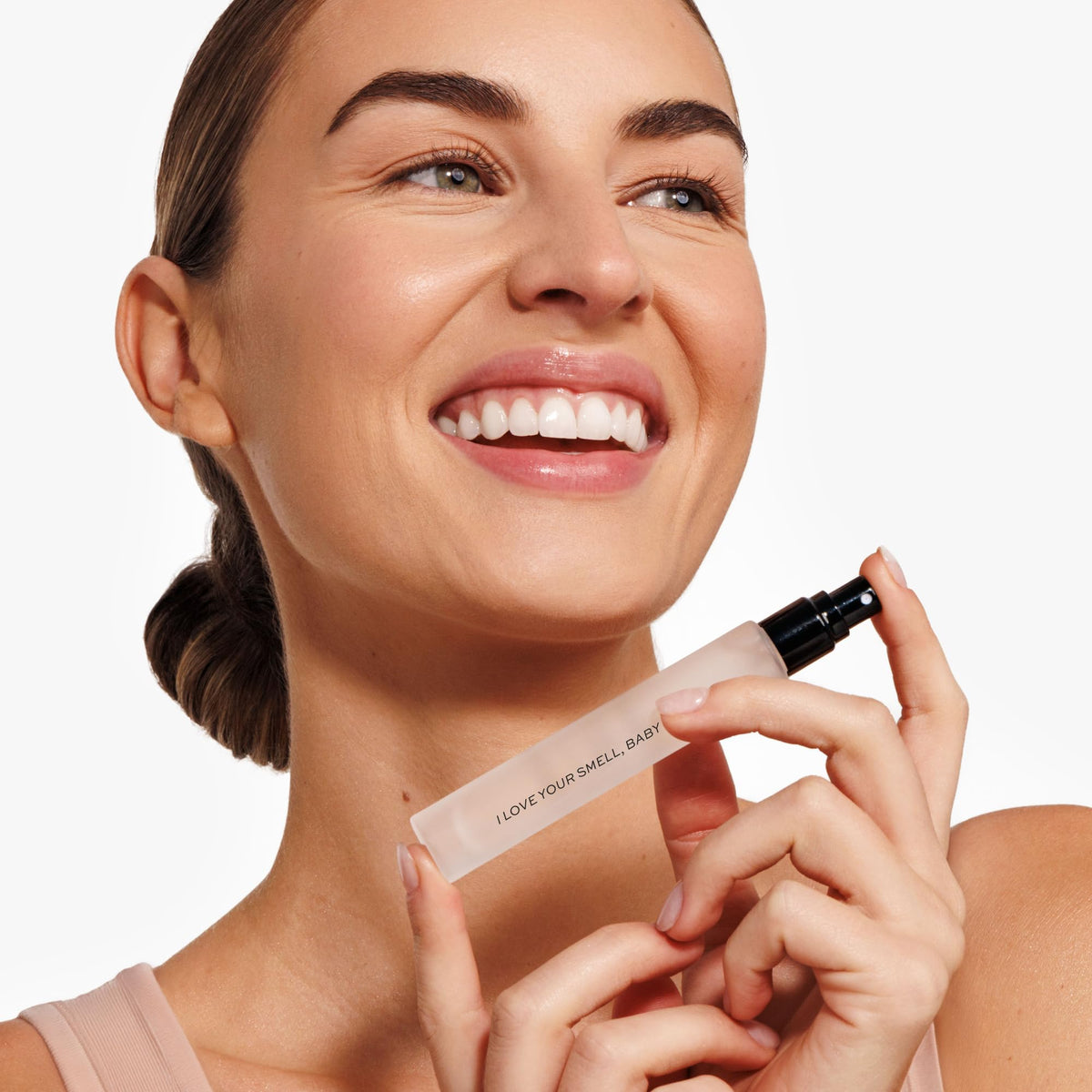 DIME travel spray held in hand to show size and convenience for on-the-go use