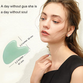 Ditind gua sha used on face demonstrating de-puffing benefit