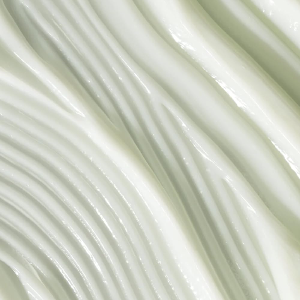 Divi conditioner applied to wet hair mid-lengths demonstrating use