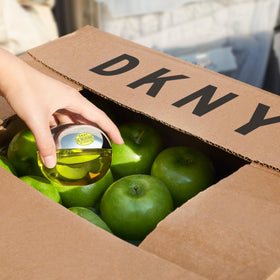 DKNY fragrance drop on skin showing texture and light reflection