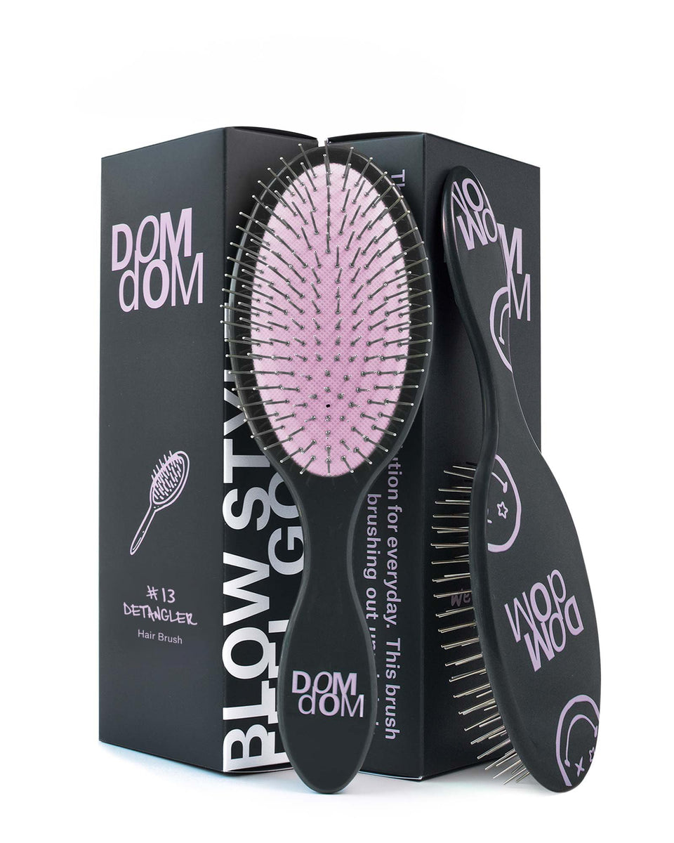 Dom Dom detangling brush front view showing compact design and easy grip benefit
