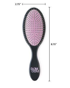 Dom Dom brush being used in shower on damp hair for fast detangling