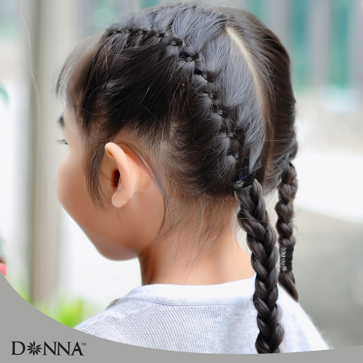DONNA bands securing a braid end for tidy finish and long-lasting hold