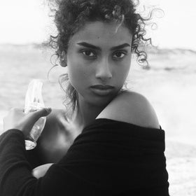 Donna Karan Cashmere Mist inside a purse lifestyle shot for on-the-go freshness
