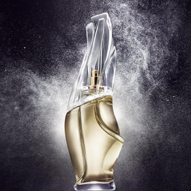 Donna Karan mist spraying from bottle demonstrating fine spray and benefit of even application