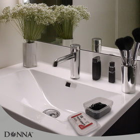 DONNA bands on a bathroom counter near styling tools showing travel-ready organization