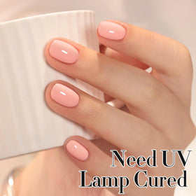 Double Rhythm nail on finger lifestyle shot showing wearable pastel pink-orange shade for everyday style