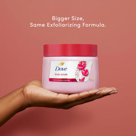 Hand scooping Dove scrub demonstrating creamy feel and easy application