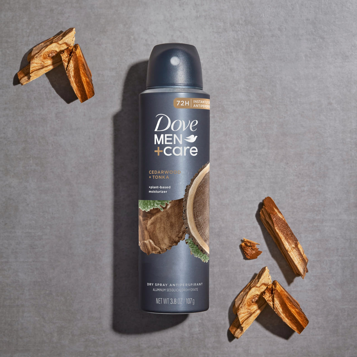 Hand spraying Dove Men+Care Cedarwood Tonka showing quick-dry protection benefit