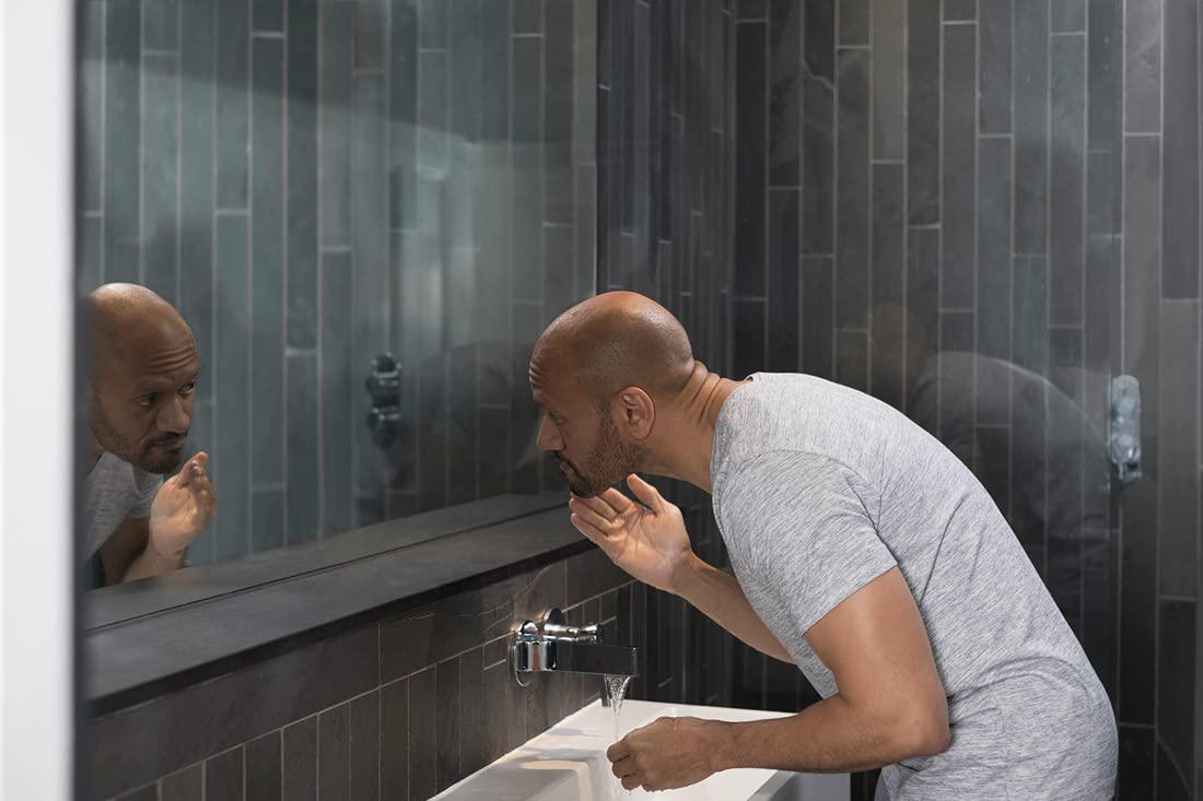 DOVE MEN + CARE rinsing with water droplets showing residue-free finish