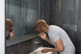 DOVE MEN + CARE rinsing with water droplets showing residue-free finish