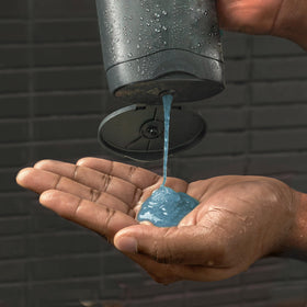 DOVE MEN + CARE size comparison next to hand showing bottle capacity convenience