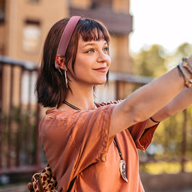 DOXISHRUKY headband in hand to show scale and stretchable one-size fit