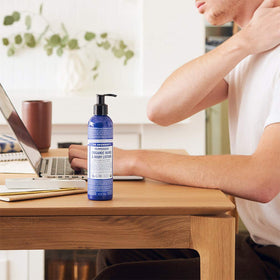 Dr. Bronner's lotion being poured into hand to show moisturization benefit