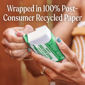 Recycled paper wrapper on Dr. Bronner's bar emphasizing reduced waste