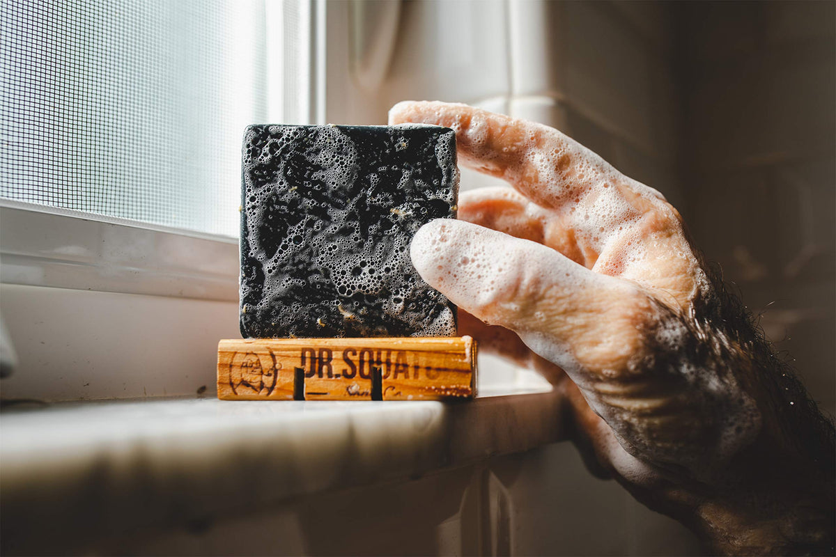 Dr. Squatch pine tar bar in bathroom setting conveying rustic lifestyle appeal