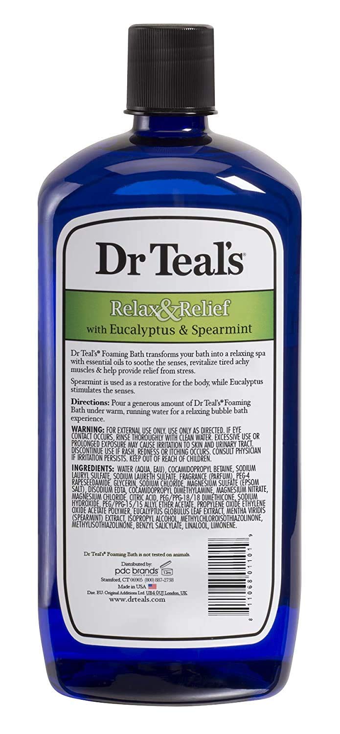 Dr Teal's bottles beside folded towel for size comparison showing generous 34 oz benefit