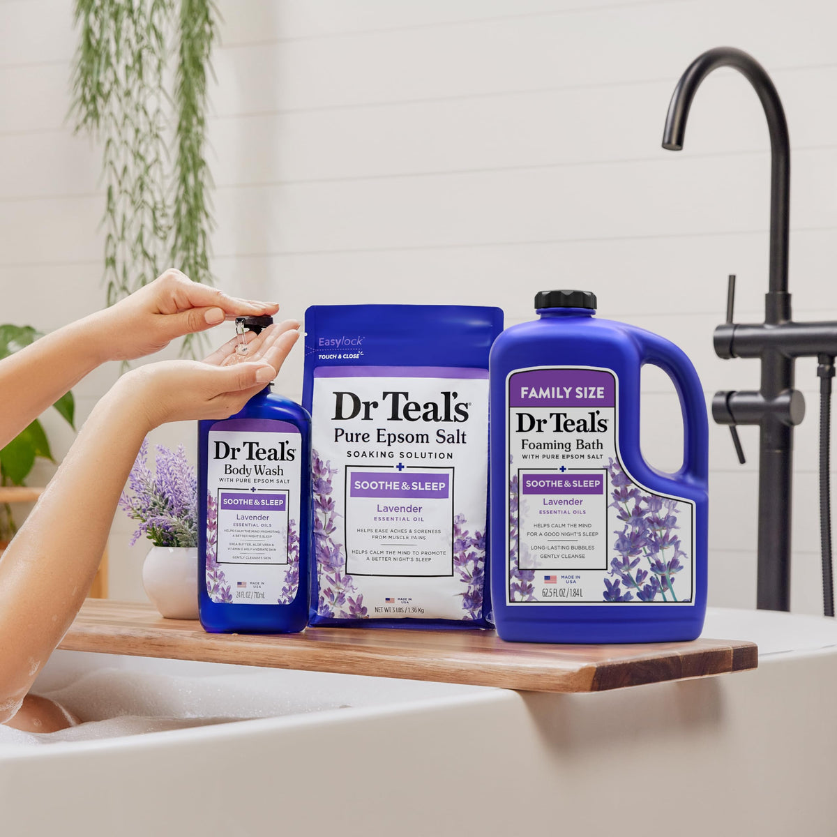 Dr Teal's bottle next to towel showing 62.5 fl oz size comparison