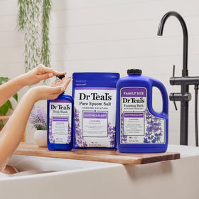 Dr Teal's bottle next to towel showing 62.5 fl oz size comparison