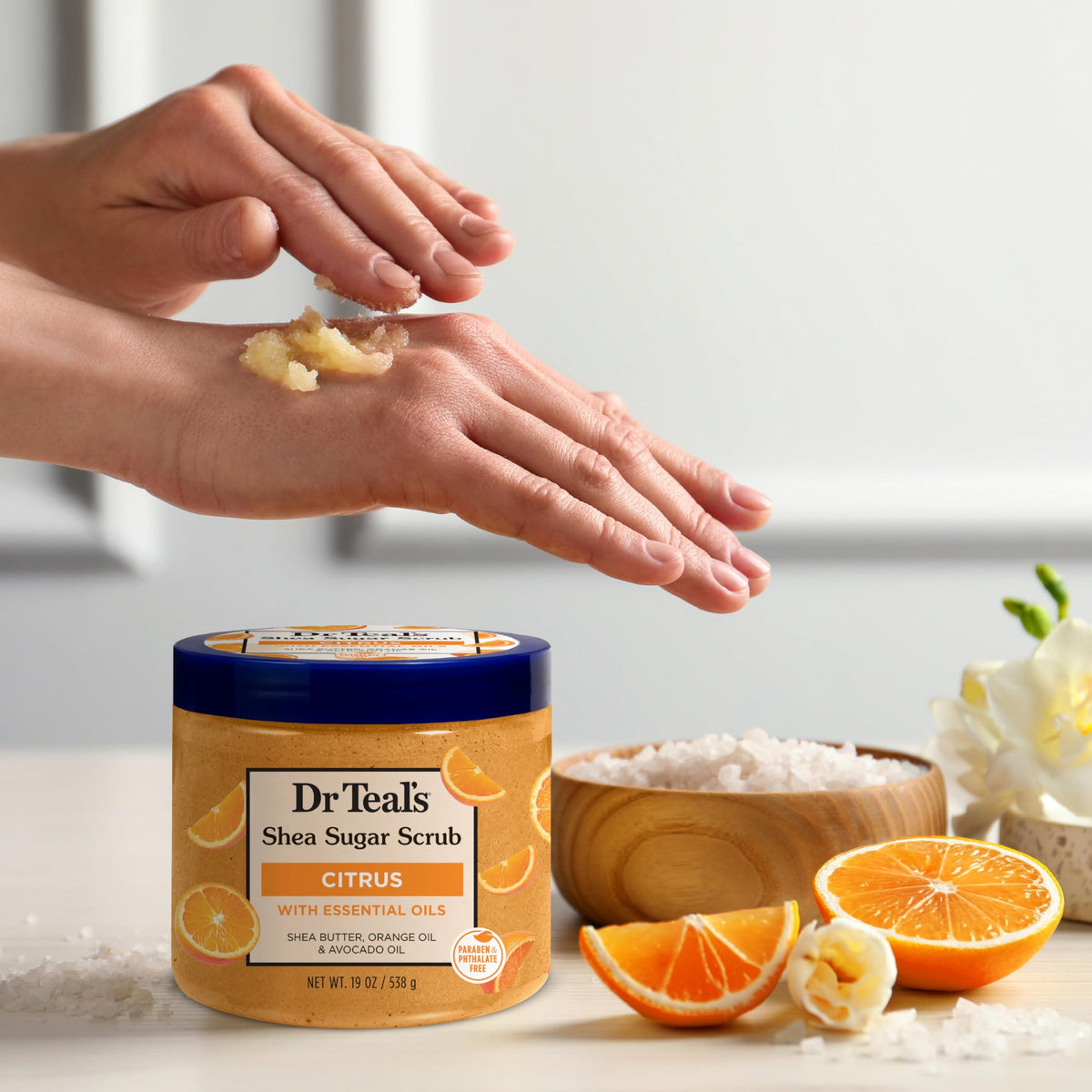 Dr Teal's jar beside a hand for scale illustrating generous 19 oz size
