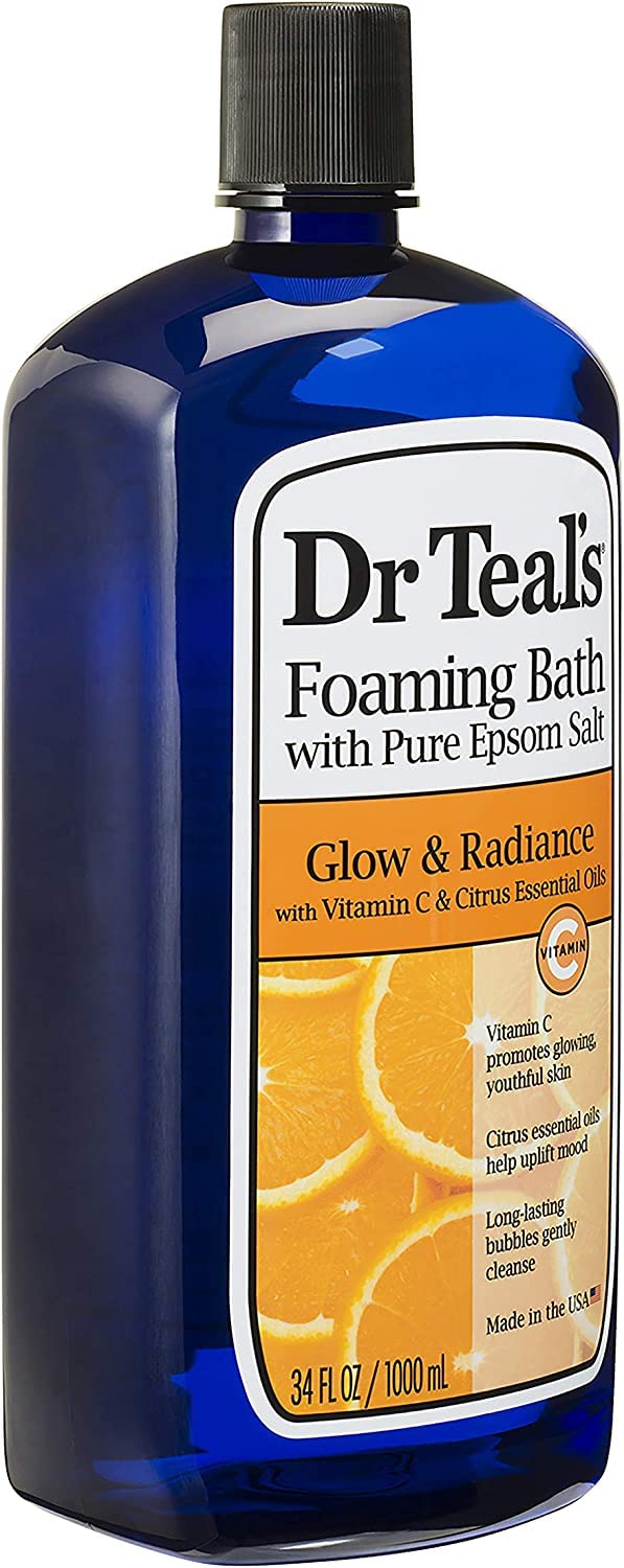 Dr Teal's bottles beside a filled bathtub creating a relaxing at-home spa vibe