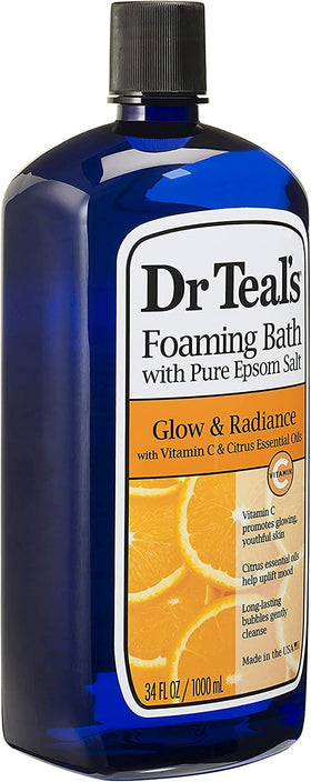 Dr Teal's bottles beside a filled bathtub creating a relaxing at-home spa vibe
