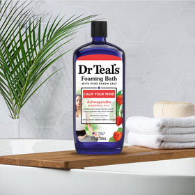 Visual of Epsom salt and botanicals beside Dr Teal's bottle signaling mineral-powered formula
