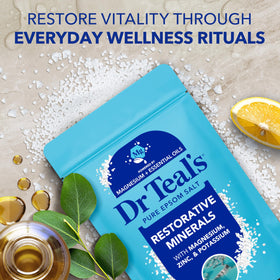 Dr Teal's product in a lit bathroom with eucalyptus sprigs, promoting calm and refreshment
