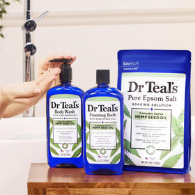 Dr Teal's bottle held in hand showing scale and travel-friendly size benefit