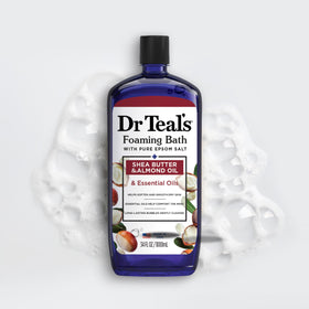 Dr Teal's 34 fl oz bottle next to a hand to show product scale
