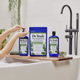 Dr Teal's bottle held in hand to illustrate 34 fl oz scale and convenient use