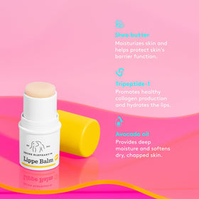 Drunk Elephant Lippe Balm beside a coin for scale showing compact, travel-friendly size
