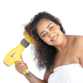 Drybar held in hand for scale to show compact size and easy handling