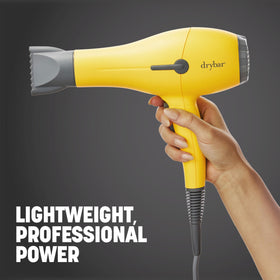 Drybar Buttercup styling in use on model for smoother shinier results