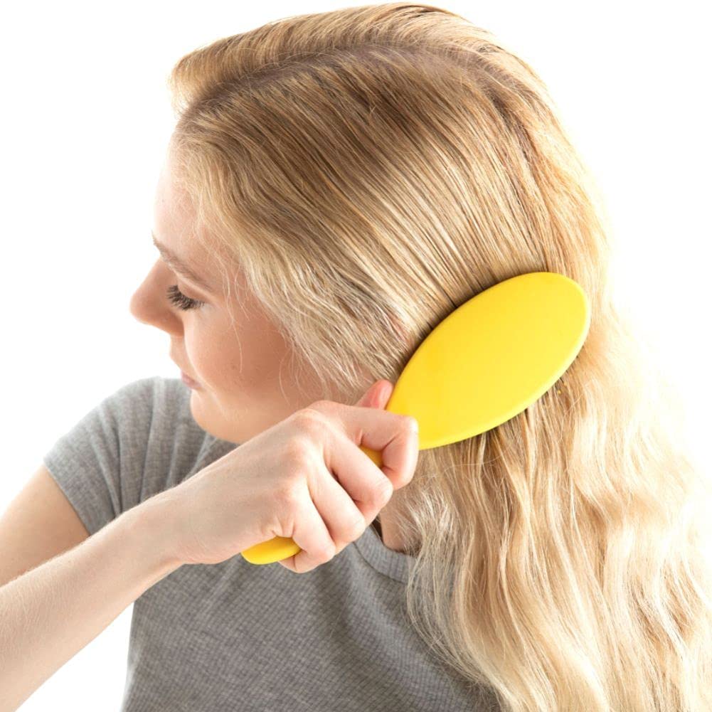 Drybar Super Lemon Drop held in hand to show scale and slip-free handle for controlled brushing