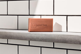 Duke Cannon soap staged in bathroom showing masculine lifestyle and grooming appeal