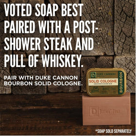 Duke Cannon bourbon solid cologne beside travel items showing portability benefit