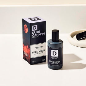 Duke Cannon bottle next to hand showing 1.7 fl oz portable travel size