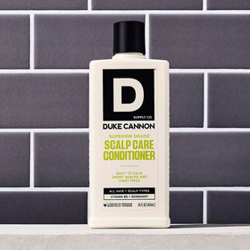 Duke Cannon bottle held in hand showing true size and portability